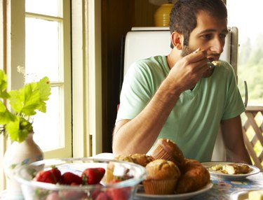 Young man eating breakfast