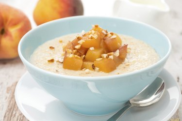 oatmeal with caramelized peaches in a bowl, jug of yogurt