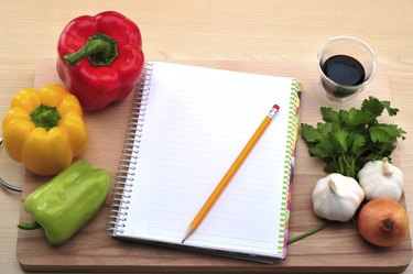 Fresh vegetables and blank recipe book