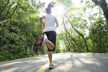 healthy lifestyle fitness sports woman  running at mountain forest road