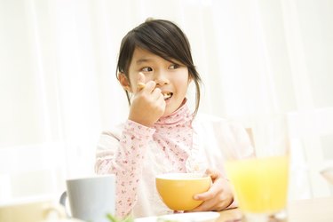 Young girl eating breakfast