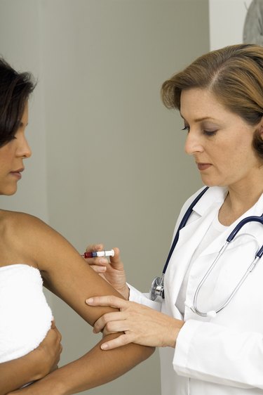 Woman doctor giving patient injection