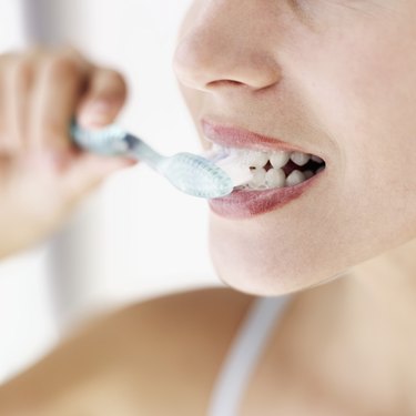 close-up of a young woman brushing her teeth