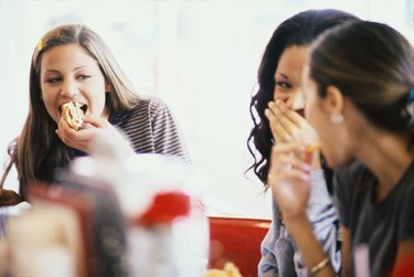 Three young women eating at a cafe