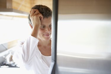 Mixed Race woman looking in refrigerator