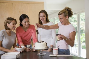 Women in kitchen preparing a cake