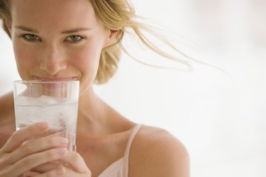 Woman holding glass of water