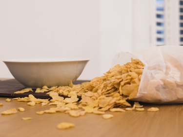 Cereal spilled near bowl on table