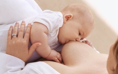 Close-up of mother breastfeeding baby girl (6-12 months)