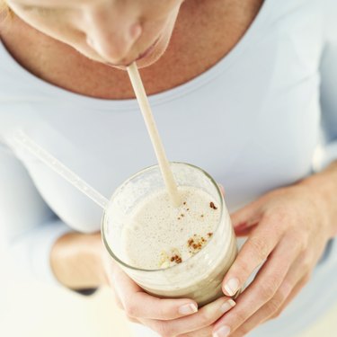 elevated view of a woman drinking a milkshake with a straw