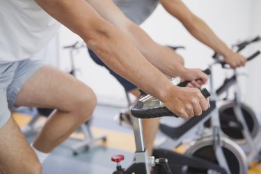 Fit people working out on the exercise bikes