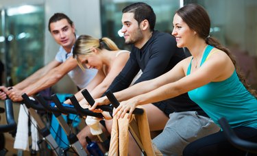 Adults riding stationary bicycles