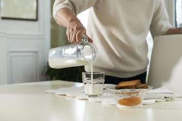 Portrait of senior woman having breakfast with milk