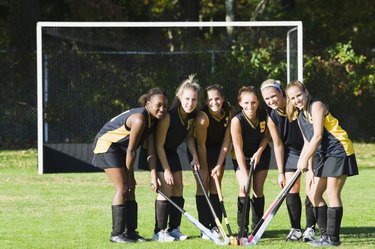 Female hockey players in a field