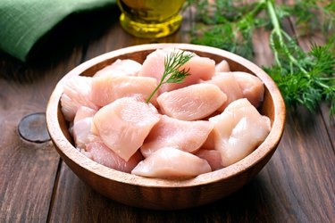 Chicken meat in wooden bowl