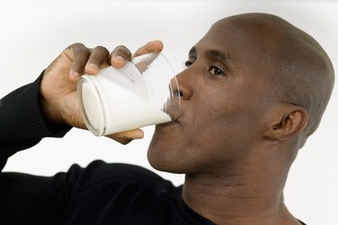 Adult man drinking glass of milk