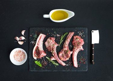 Raw lamb chops. Rack of Lamb with garlic, rosemary and