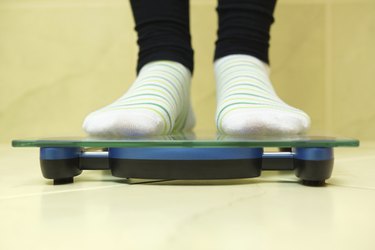 Woman standing on scales