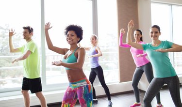 A group of smiling people in an aerobics class