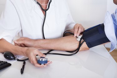 Doctor taking a patients blood pressure