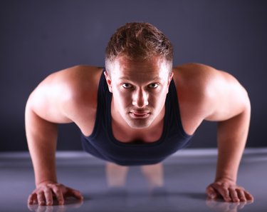 Fitness man doing push ups on floor