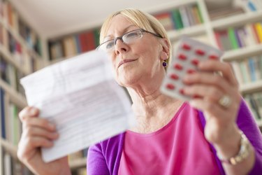 Senior woman with medication pills and prescription