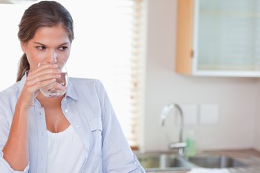 Gorgeous woman drinking a glass of water