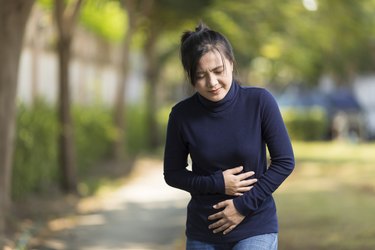 Woman Has Stomach Ache at Park