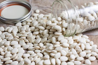 Dry Lima beans spilled on a countertop