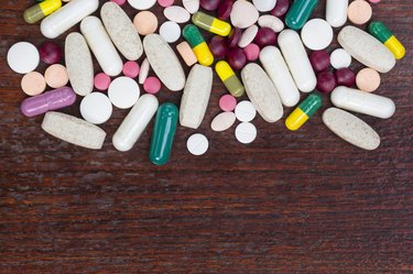 many colorful medicines on wood table