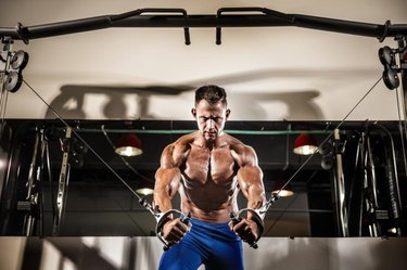Young Bodybuilder Is Working On His Chest With Cable Crossover In Gym