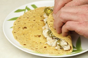 Hands Rolling a Vegetarian Wrap