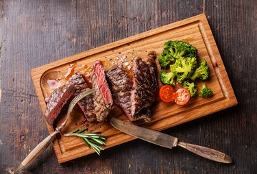 Sliced medium rare grilled steak Ribeye with broccoli