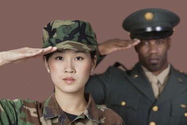 Close-up portrait of young female US Marine Corps soldier with male officer saluting over brown background