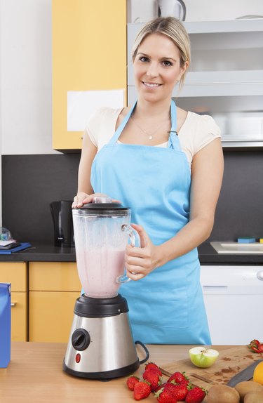 Woman Making Strawberry Milkshake
