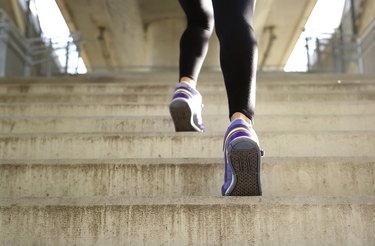 Sports female running up stairs