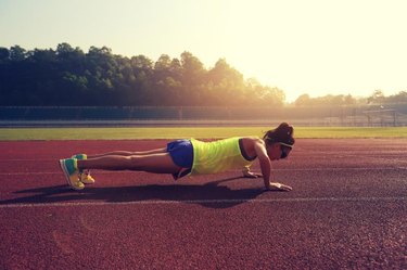 young fitness woman runner push up before run