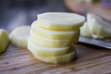 Stack of sliced purified potatoes, cooking delicious dishes