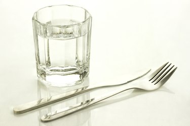Knife and fork with a glass of water