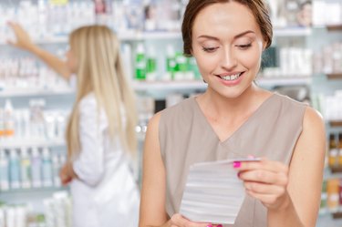 Beautiful girl pharmacist helping a customer