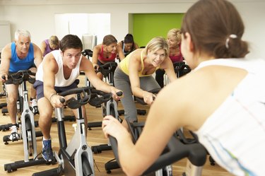 Group Doing Spinning Class In Gym