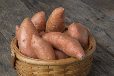 Sweet Potatoes in Basket on Wood Table