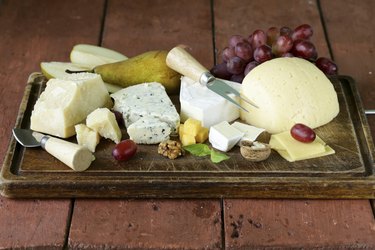 cheeseboard with assorted cheeses (parmesan, brie, blue, cheddar)