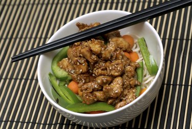 A bowl of high-protein Chinese food with chopsticks