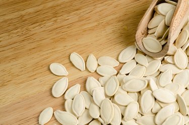 dried pumpkin seeds, on wooden background