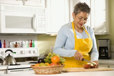 Woman cutting apples in kitchen