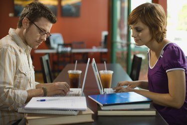 Couple working on laptop computers