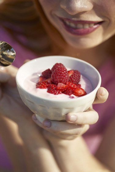 Woman with yogurt and strawberries