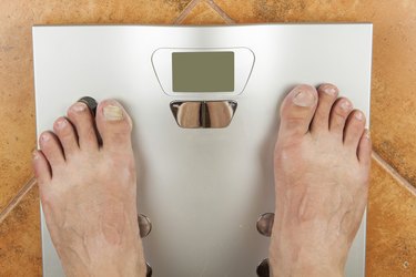 Man looks at a personal scale.