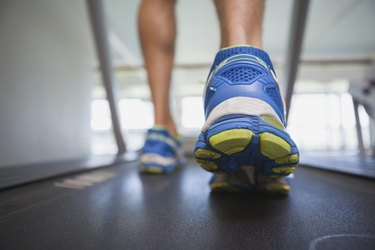 Low section of a man running on treadmill